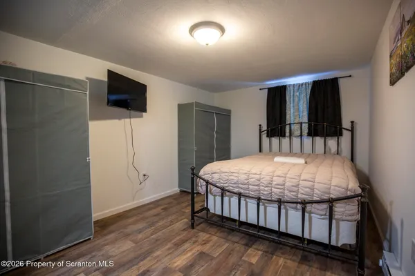 a bedroom with a bed and a television