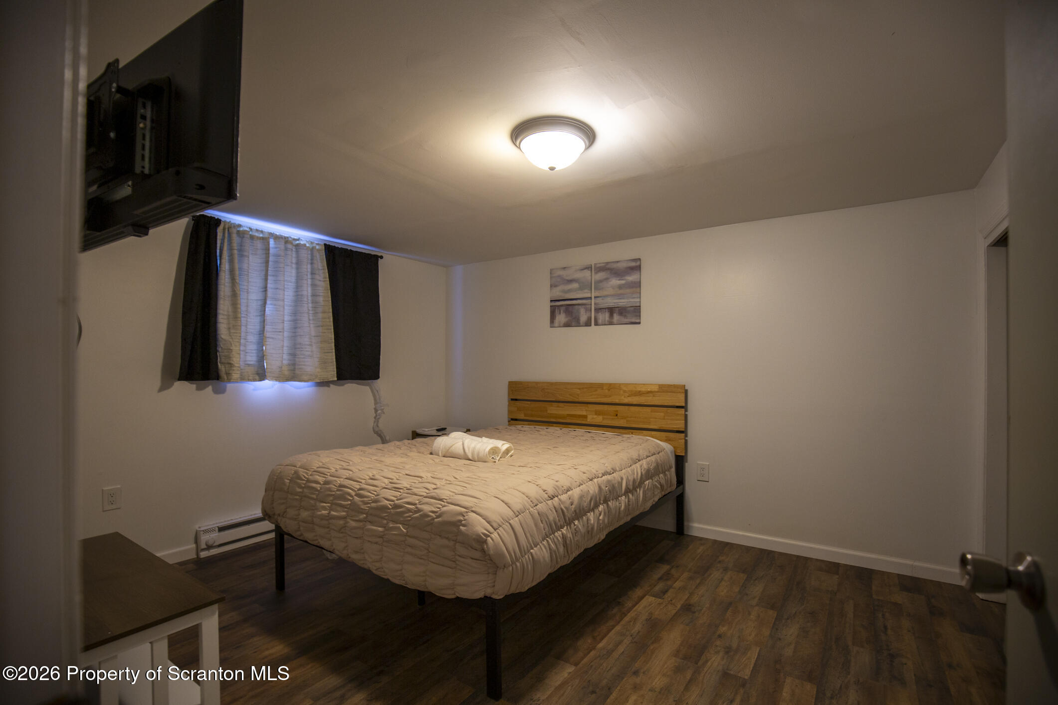 544 Sullivan Trail Long Pond, PA 18334 - Photo 53 of 68 a bedroom with a bed and wooden floor
