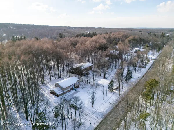an aerial view of residential houses with city view