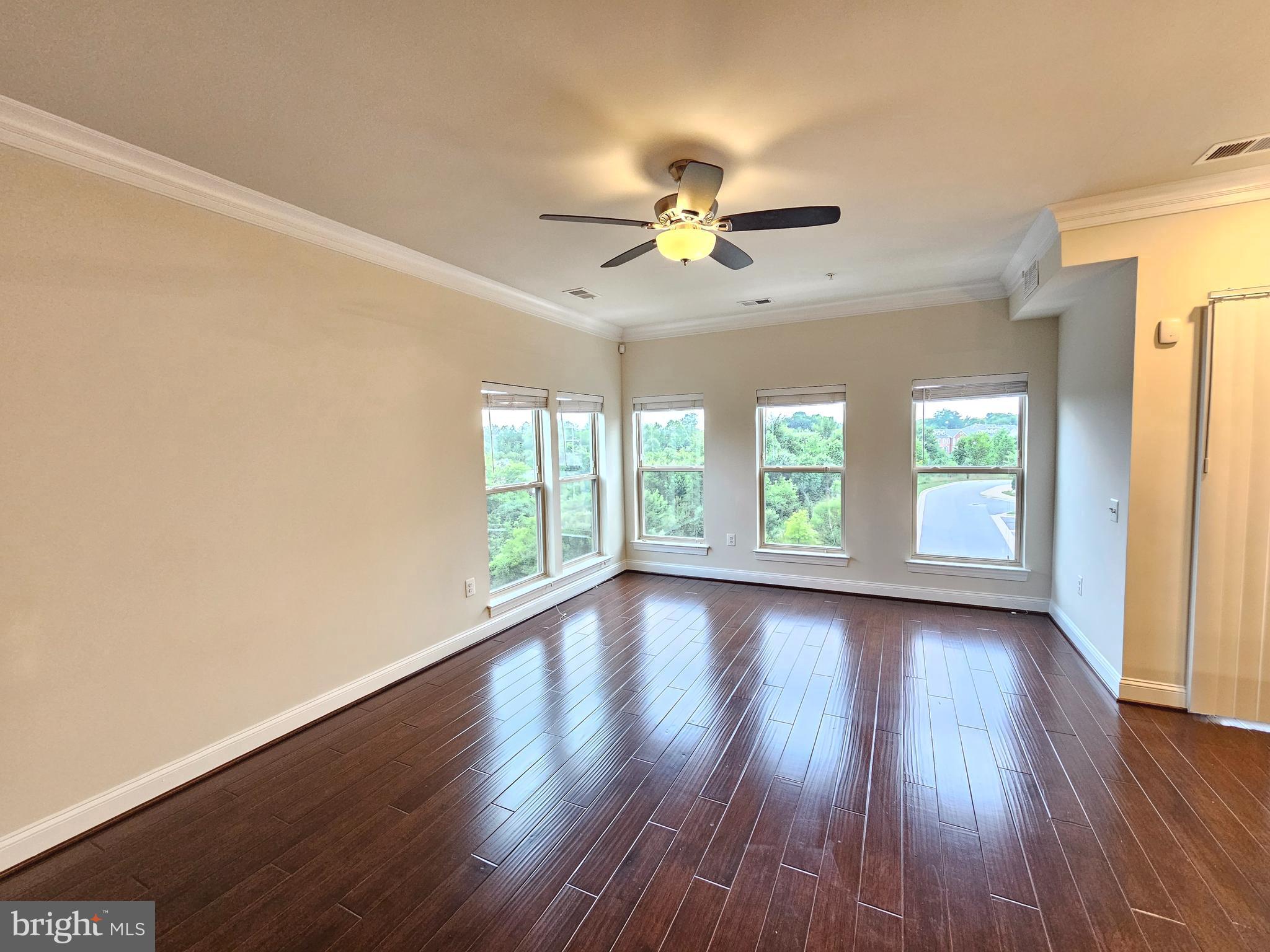 164 Copley Circle, Unit 27B Gaithersburg, MD 20878 - Photo 13 of 34 a view of room with window ceiling fan and hardwood floor