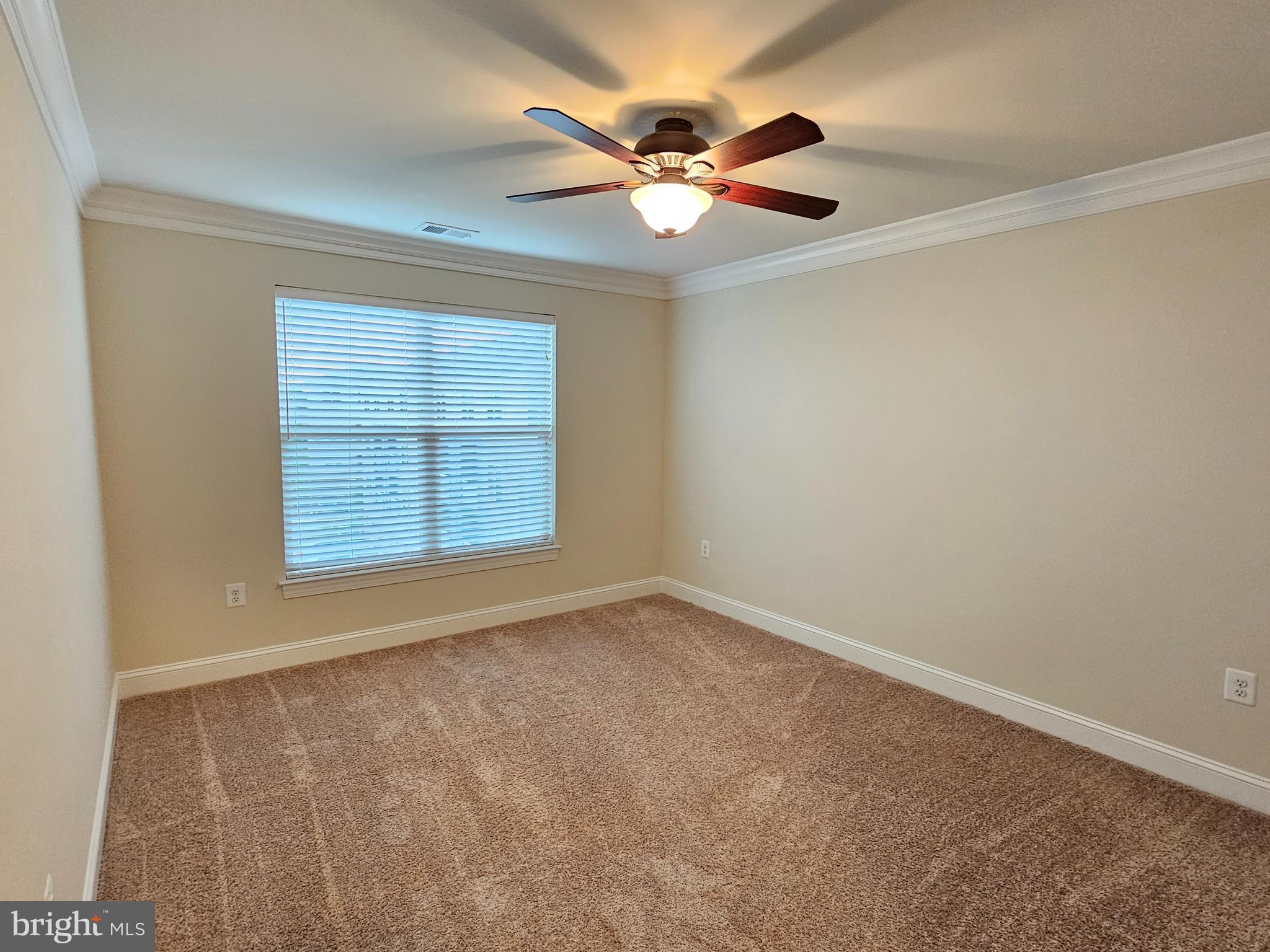 164 Copley Circle, Unit 27B Gaithersburg, MD 20878 - Photo 28 of 34 an empty room with windows and fan