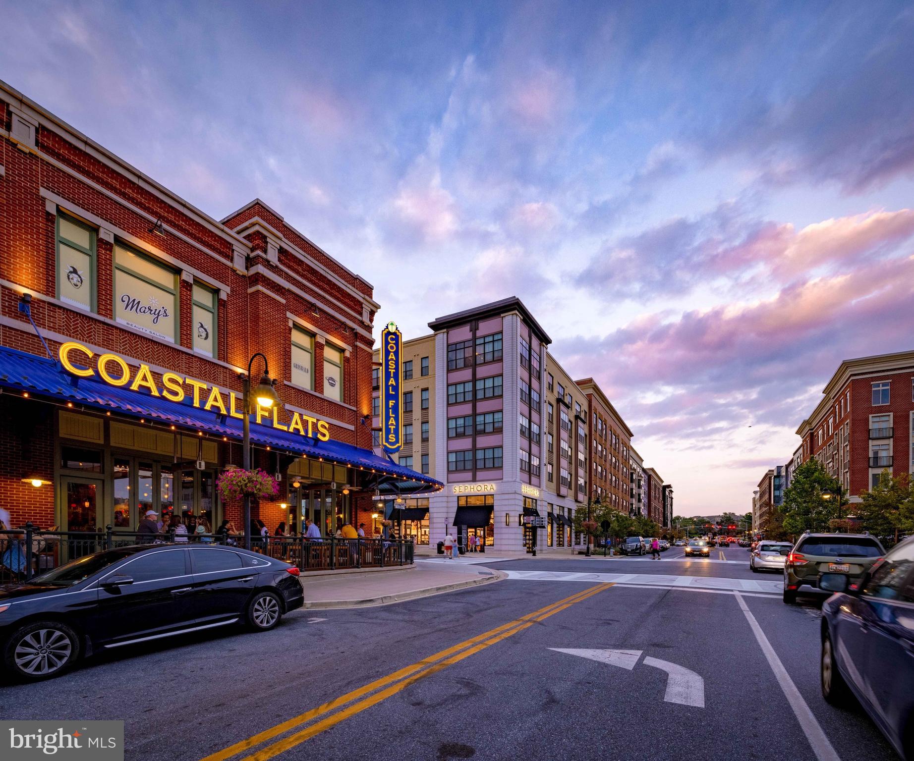 164 Copley Circle, Unit 27B Gaithersburg, MD 20878 - Photo 32 of 34 a city street lined with parked cars and buildings