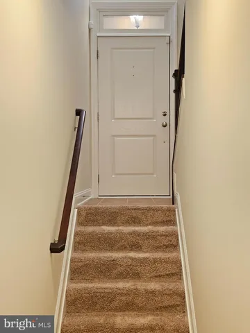 a view of staircase with white walls