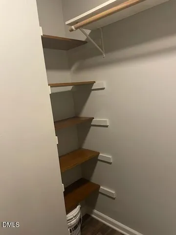 a bathroom with a toilet and a chair