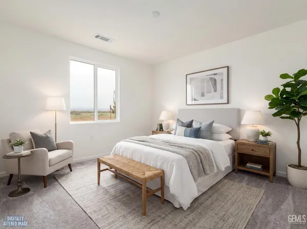 a bedroom with a bed and a potted plant