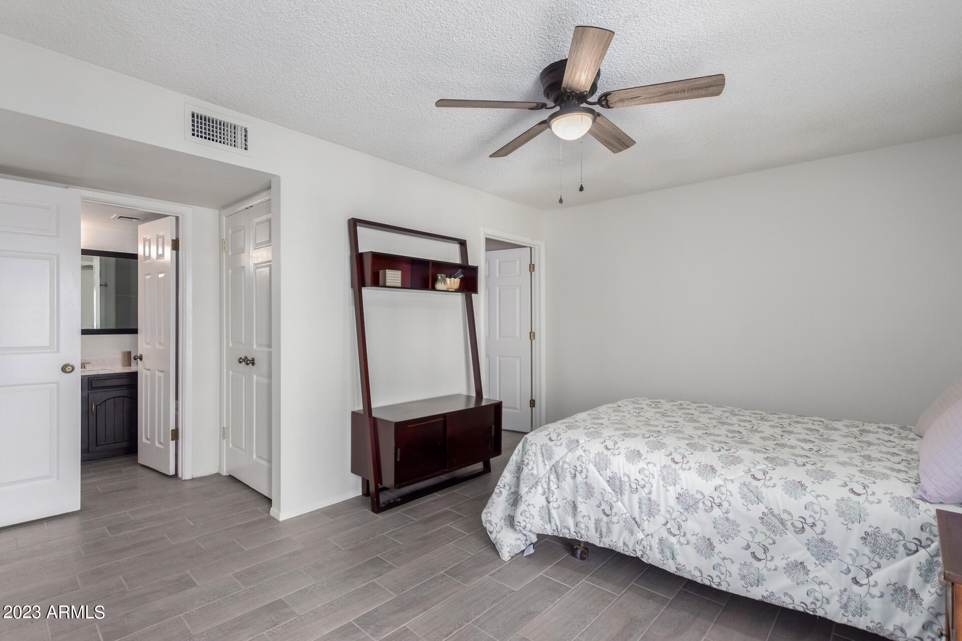 709 South Power Road, Unit 105 Mesa, AZ 85206 - Photo 18 of 36 a bedroom with a bed and a ceiling fan
