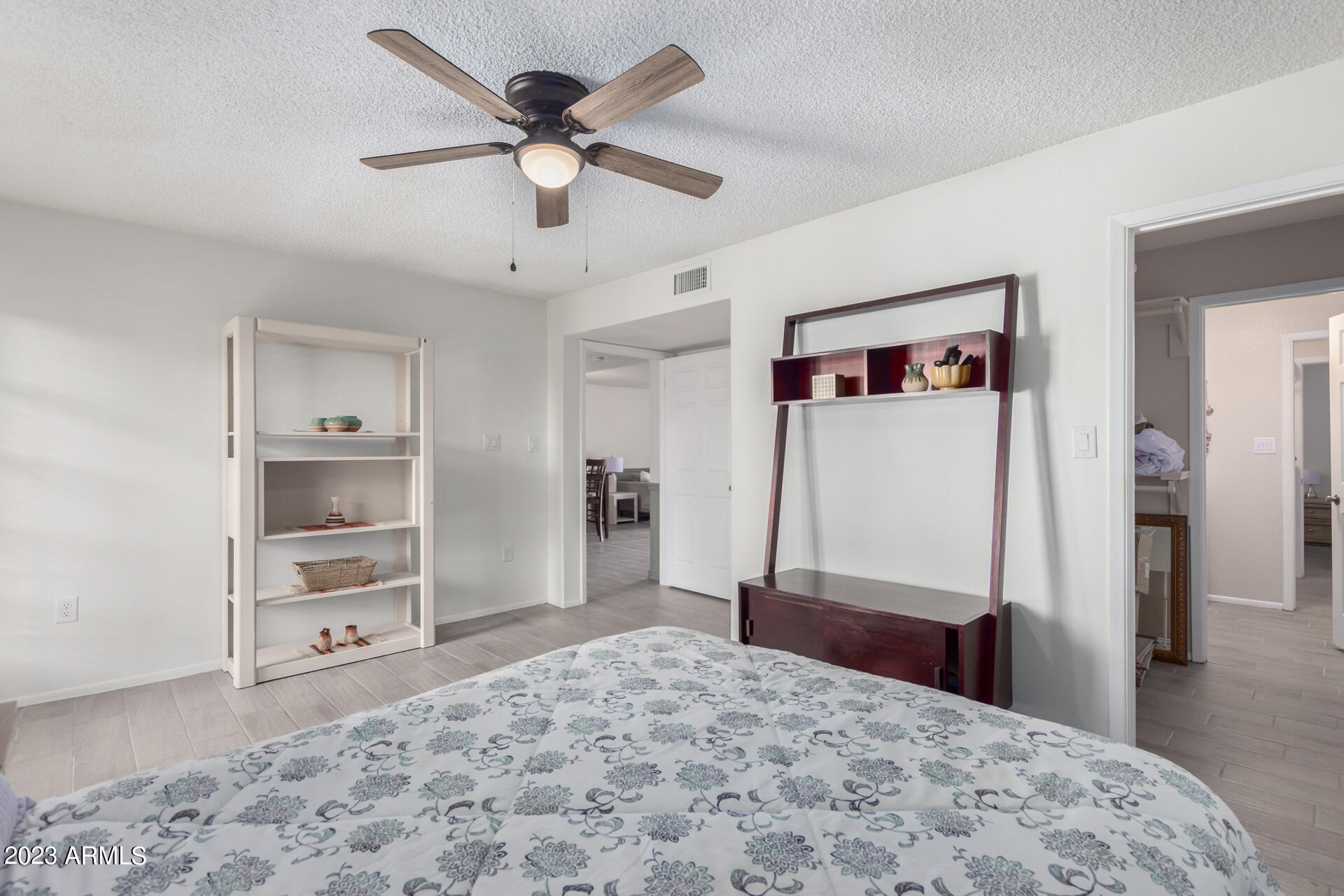 709 South Power Road, Unit 105 Mesa, AZ 85206 - Photo 19 of 36 a bedroom with a bed and a dresser
