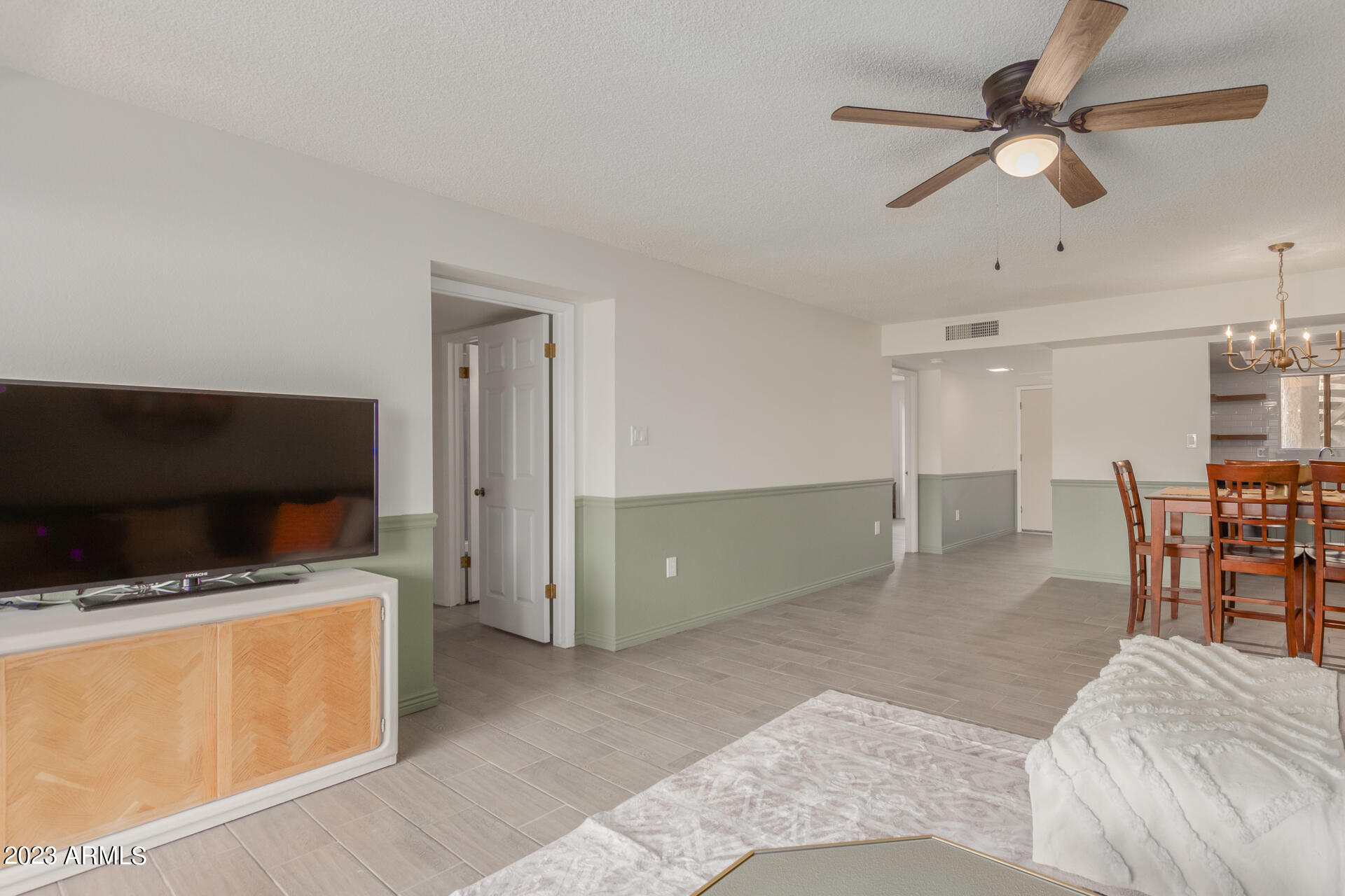 709 South Power Road, Unit 105 Mesa, AZ 85206 - Photo 4 of 36 a spacious bedroom with a bed and a flat screen tv