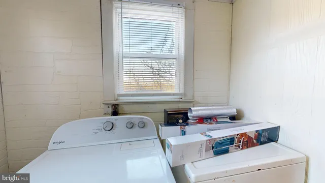 a bathroom with a bathtub and a window