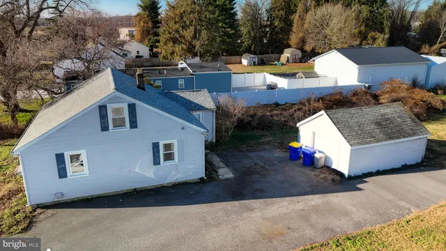 a aerial view of a house with a yard and sitting area