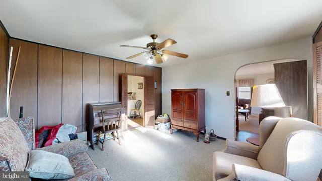 a living room with furniture a fireplace and a chandelier