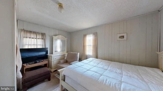 a bedroom with furniture and flat screen tv
