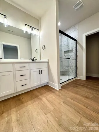 a view of a kitchen with cabinet and mirrors