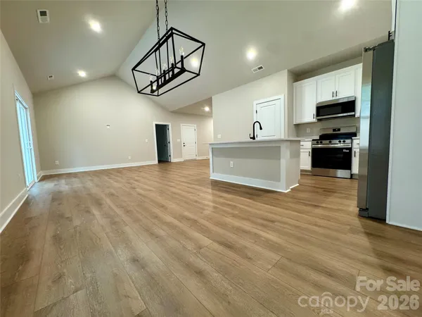 a view of a kitchen with microwave and cabinets