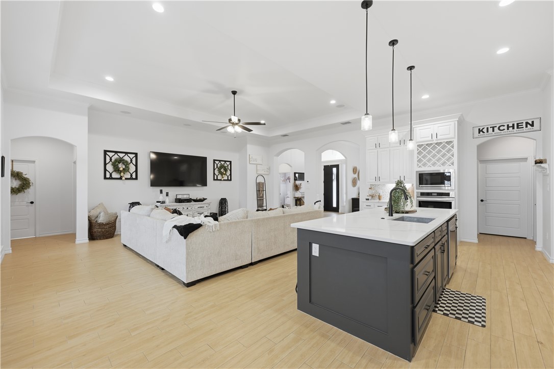 105 Sapphire Street Portland, TX 78374 - Photo 11 of 29 a living room with stainless steel appliances kitchen island furniture and a flat screen tv