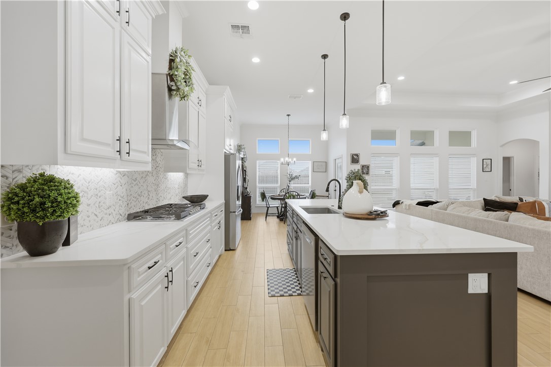 105 Sapphire Street Portland, TX 78374 - Photo 13 of 29 a kitchen with sink a stove and cabinets