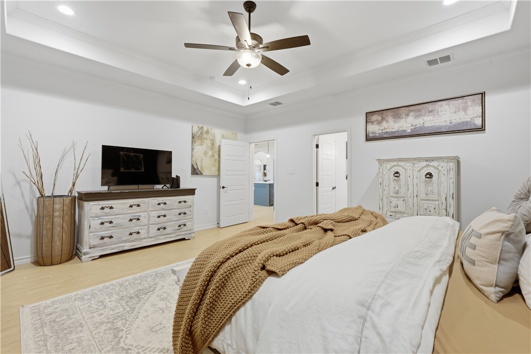 105 Sapphire Street Portland, TX 78374 - Photo 19 of 29 a bedroom with a bed a flat screen tv and a dresser with a flat screen tv