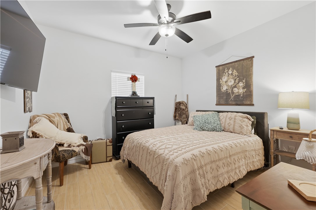 105 Sapphire Street Portland, TX 78374 - Photo 23 of 29 a bedroom with a bed and wooden floor