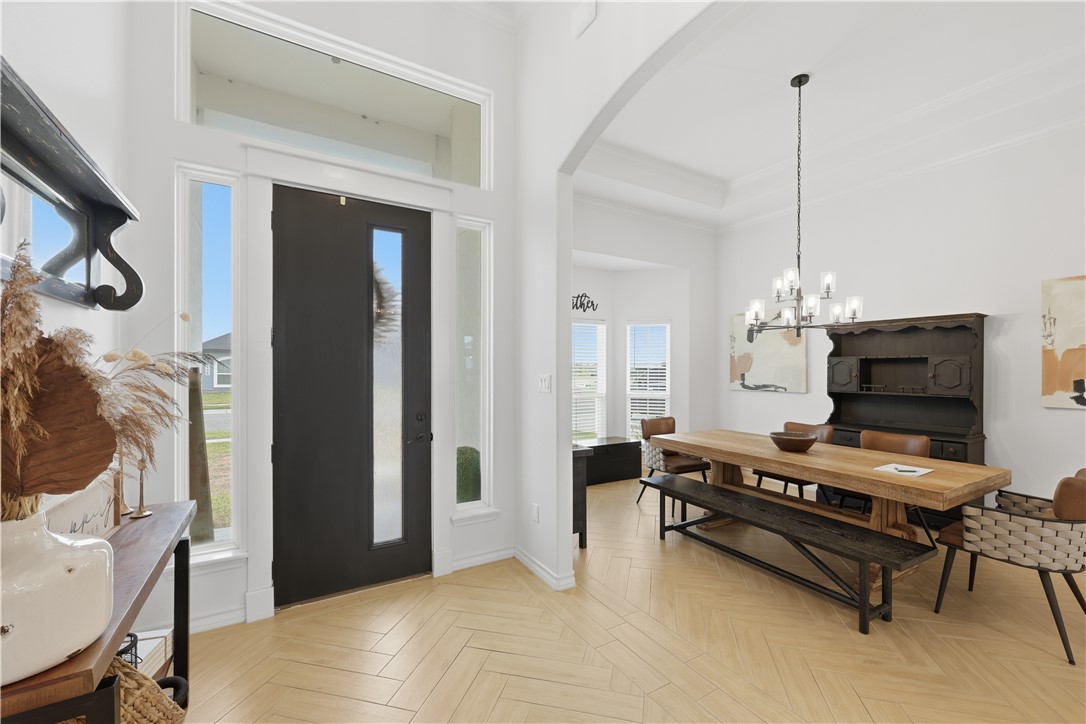 105 Sapphire Street Portland, TX 78374 - Photo 3 of 29 a bedroom with furniture and a chandelier