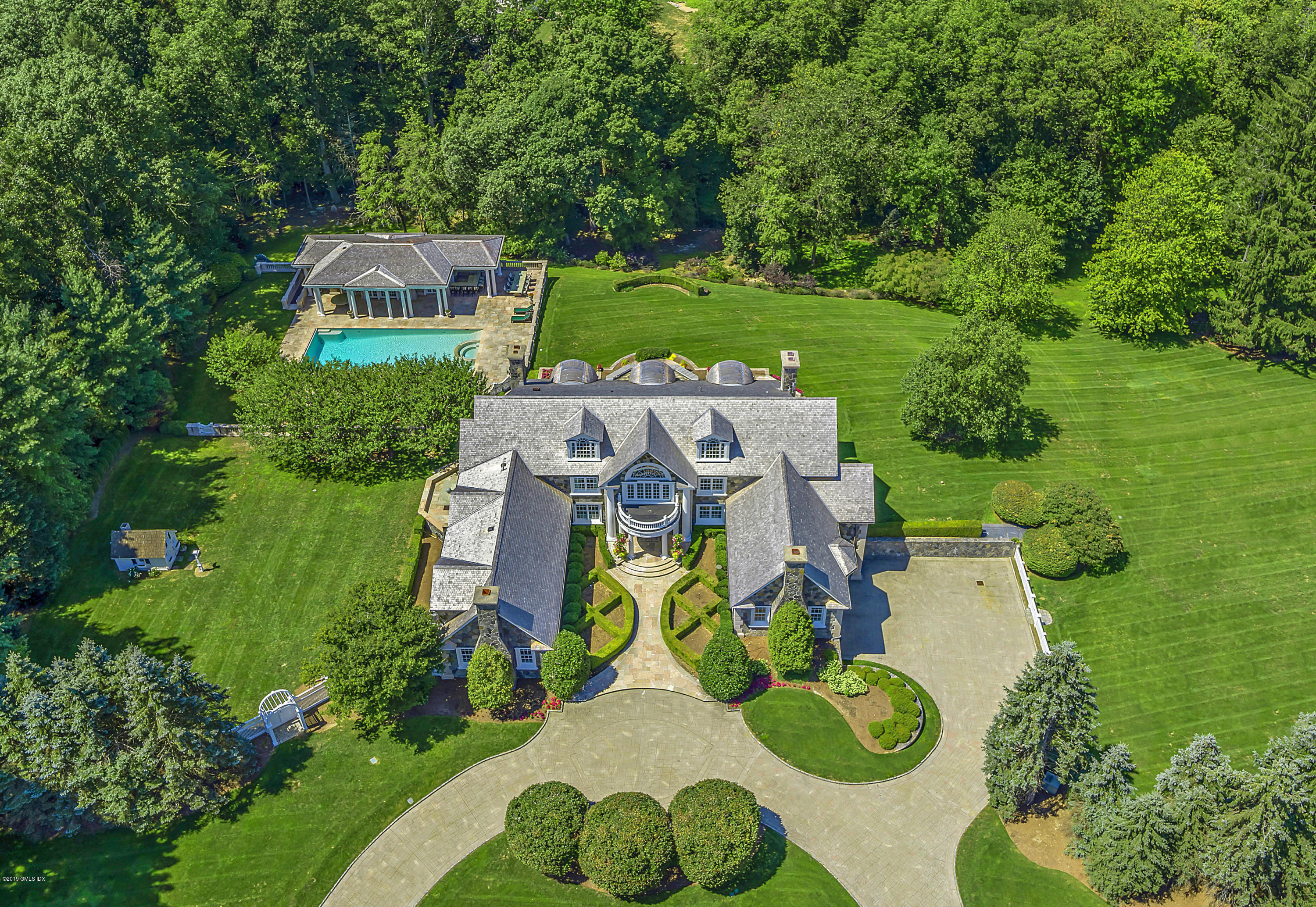 an aerial view of a house with garden space and street view