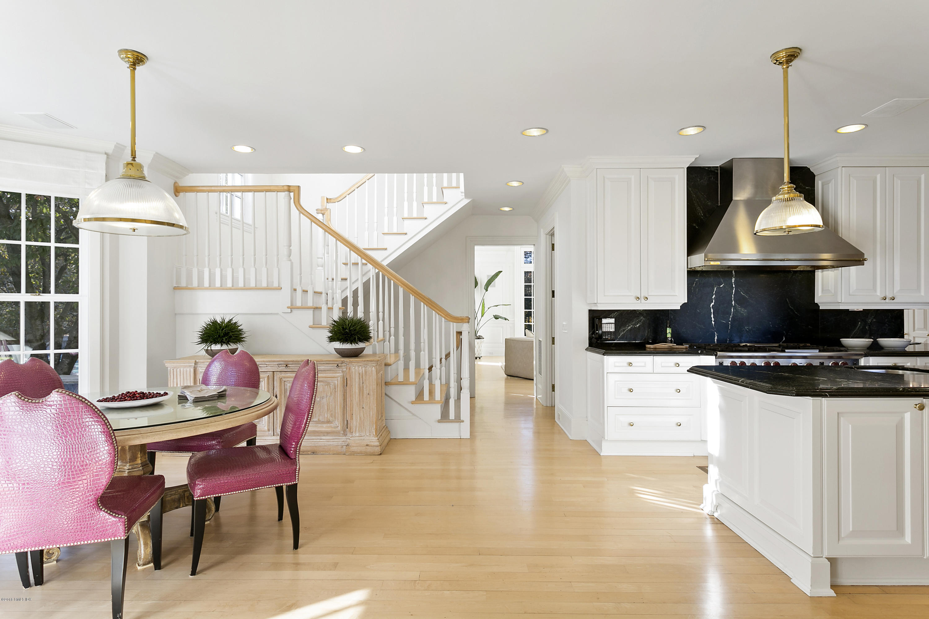 20 Andrews Farm Road Greenwich, CT 06831 - Photo 11 of 39 a kitchen with stainless steel appliances kitchen island granite countertop a stove a sink a dining table and chairs