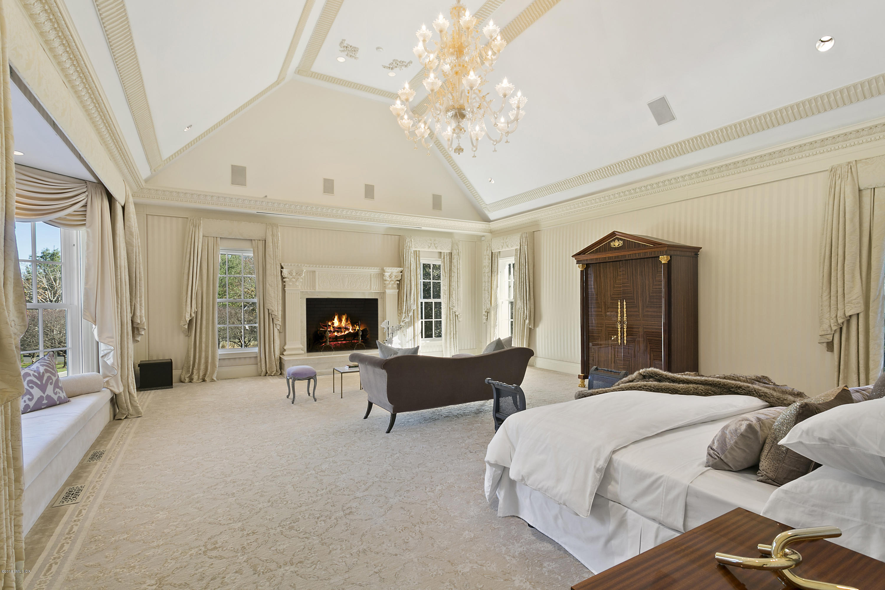 20 Andrews Farm Road Greenwich, CT 06831 - Photo 19 of 39 a spacious bedroom with bed and a chandelier