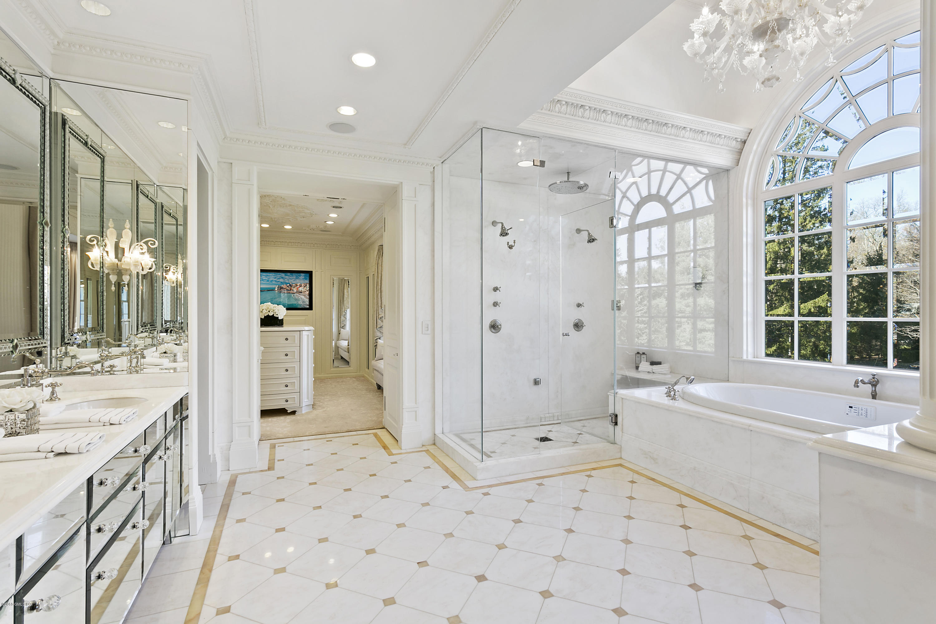 20 Andrews Farm Road Greenwich, CT 06831 - Photo 21 of 39 a bathroom with a sink a bathtub a large mirror and a bathtub with shower
