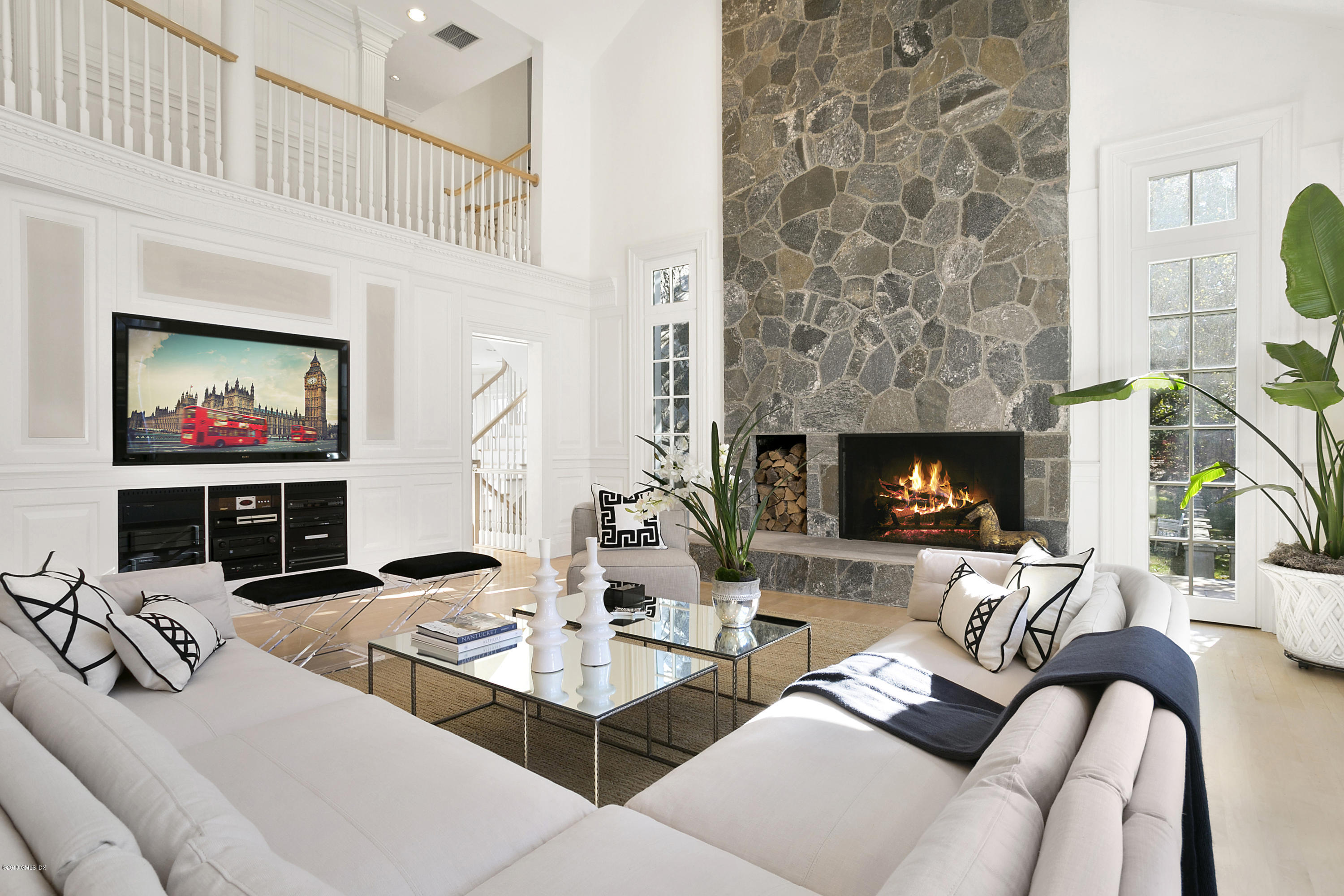 20 Andrews Farm Road Greenwich, CT 06831 - Photo 10 of 39 a living room with furniture a fireplace and a flat screen tv