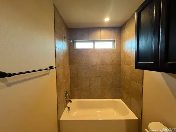 a bathroom with a bathtub and shower