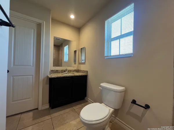 a bathroom with a sink a toilet and mirror
