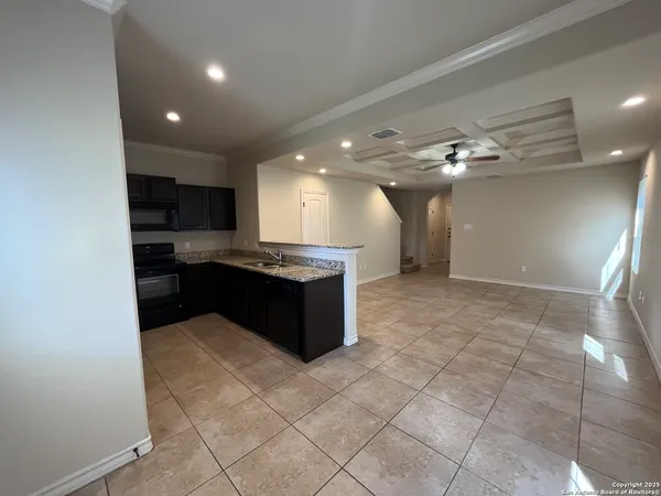 a large kitchen with a large counter top and cabinets