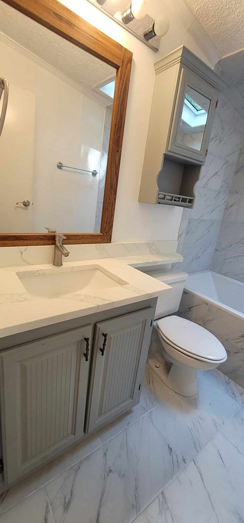 125 Sputnik Street Fortson, GA 31808 - Photo 13 of 30 a bathroom with a sink a toilet and mirror
