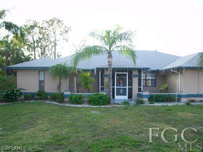 17464 Lee Road Fort Myers, FL 33967 - Photo 1 of 10 a front view of a house with garden