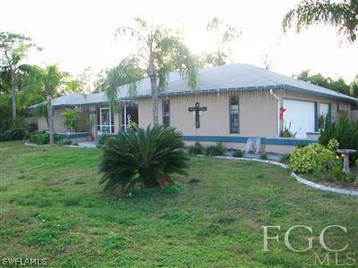 17464 Lee Road Fort Myers, FL 33967 - Photo 2 of 10 a front view of a house with garden