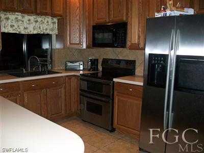17464 Lee Road Fort Myers, FL 33967 - Photo 4 of 10 a kitchen with a sink and stainless steel appliances