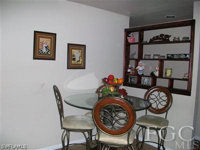 17464 Lee Road Fort Myers, FL 33967 - Photo 5 of 10 a dining room with furniture and wooden floor