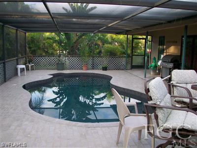 17464 Lee Road Fort Myers, FL 33967 - Photo 9 of 10 a view of a patio with table and chairs potted plants with wooden floor