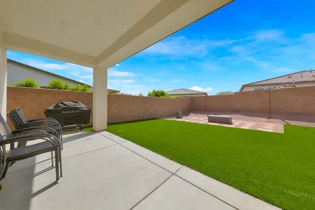 a view of a garden with lawn chairs