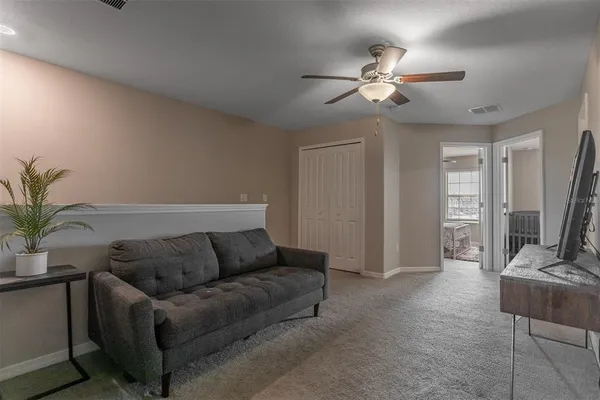 a living room with furniture and a chandelier