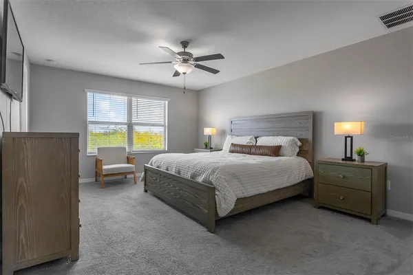 a bedroom with a bed and a chandelier