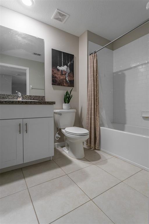 14206 Easy Goer Street Ruskin, FL 33573 - Photo 15 of 28 a bathroom with a toilet sink and mirror