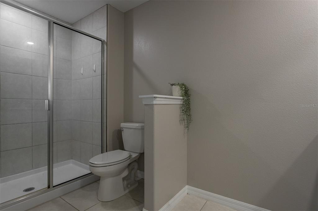14206 Easy Goer Street Ruskin, FL 33573 - Photo 18 of 28 a bathroom with a toilet and a shower