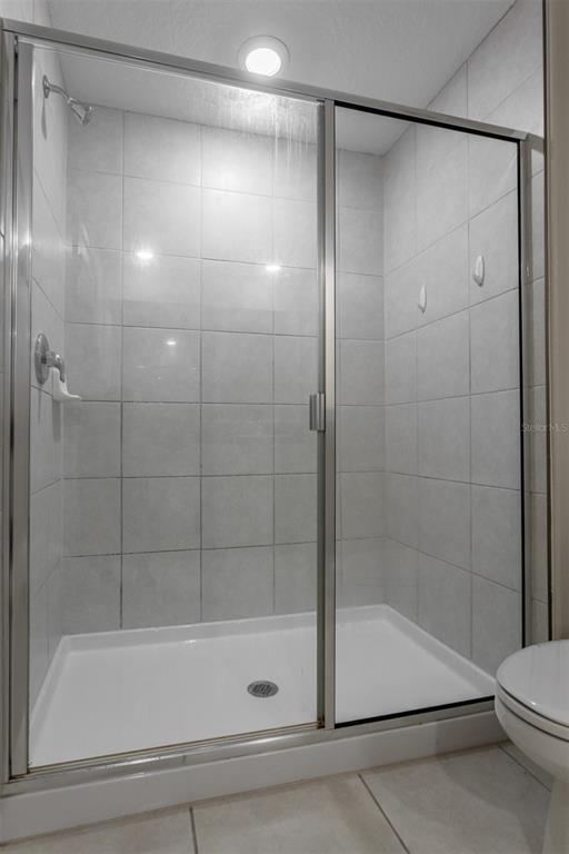 14206 Easy Goer Street Ruskin, FL 33573 - Photo 20 of 28 a bathroom with a shower and a bathtub