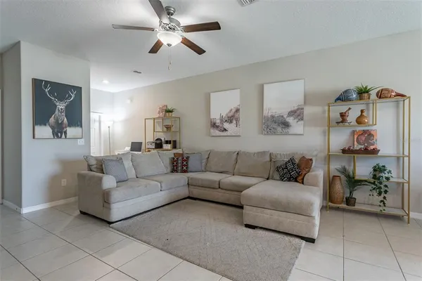 a living room with furniture and a chandelier