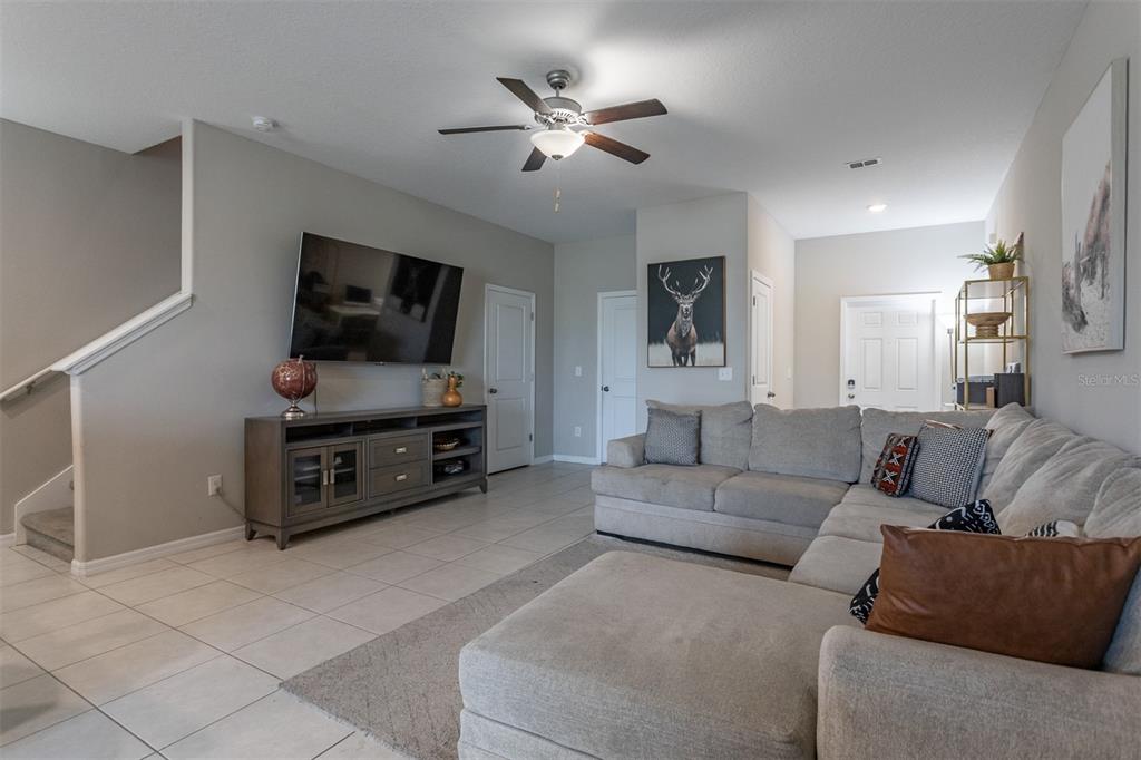 14206 Easy Goer Street Ruskin, FL 33573 - Photo 4 of 28 a living room with furniture and a flat screen tv