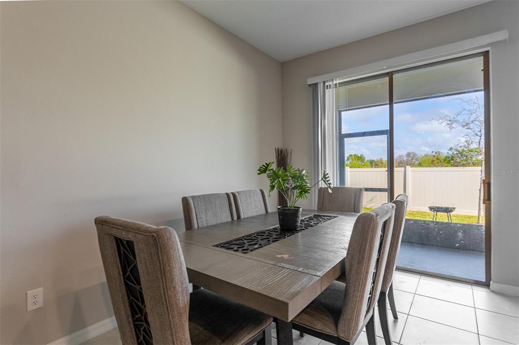 14206 Easy Goer Street Ruskin, FL 33573 - Photo 8 of 28 a view of a dining room with furniture window and wooden floor
