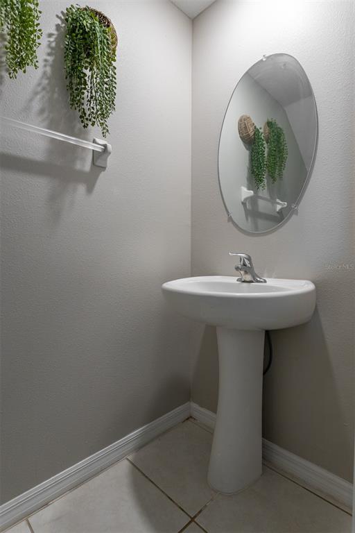 14206 Easy Goer Street Ruskin, FL 33573 - Photo 9 of 28 a bathroom with a sink a mirror and vanity