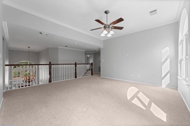 a view of a hallway with a ceiling fan