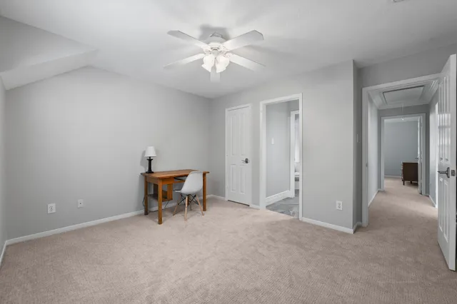 a view of a livingroom with a couch and a ceiling fan