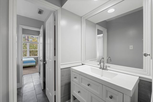 a en suite bathroom with a double vanity sink and a mirror
